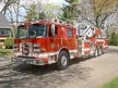Tower ladder front-left exterior view showing enclosed cab and aerial sections