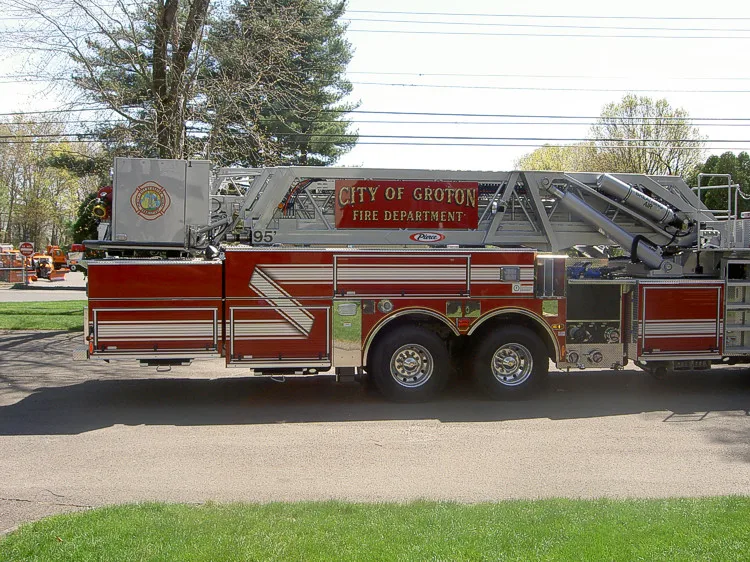 Driver-side profile showing ladder bed and tandem rear axles