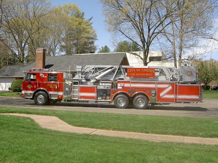Passenger-side profile showing aerial ladder sections and long wheelbase