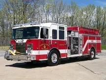 Pumper front-left exterior view showing enclosed cab and side compartments