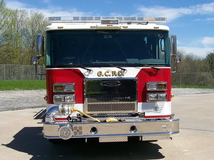 Front exterior view showing grille, bumper, and warning lights