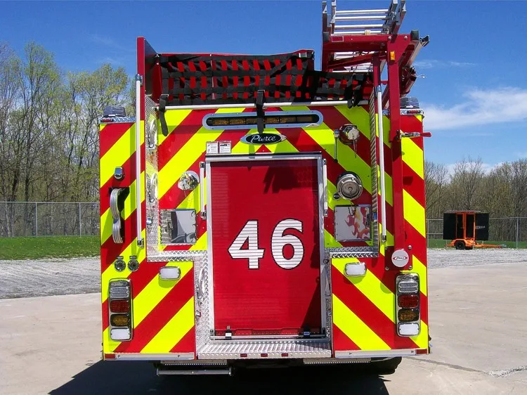 Rear view showing chevron striping, rear door panel, and upper hosebed