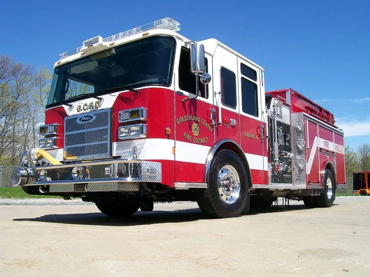 Low front-right exterior view showing bumper, cab, and side compartments