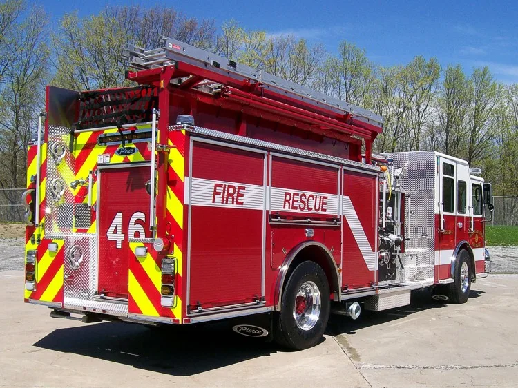 Rear-right exterior view showing hosebed rails, rear body, and wheel area