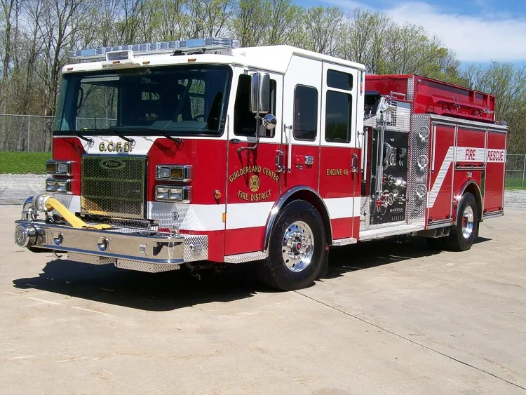 Front-left exterior view showing cab, bumper, and side compartments