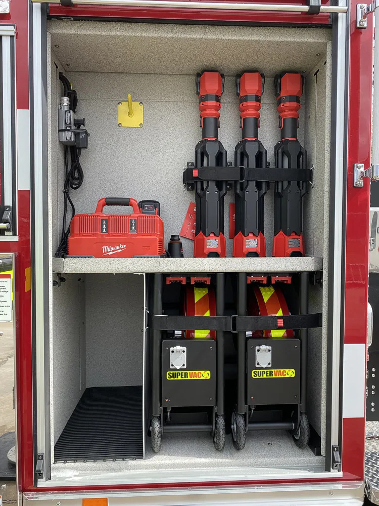 Open side compartment showing mounted extinguishers and side storage