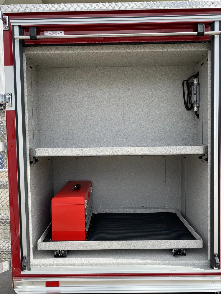 Open side compartment showing empty shelf bay with one red case