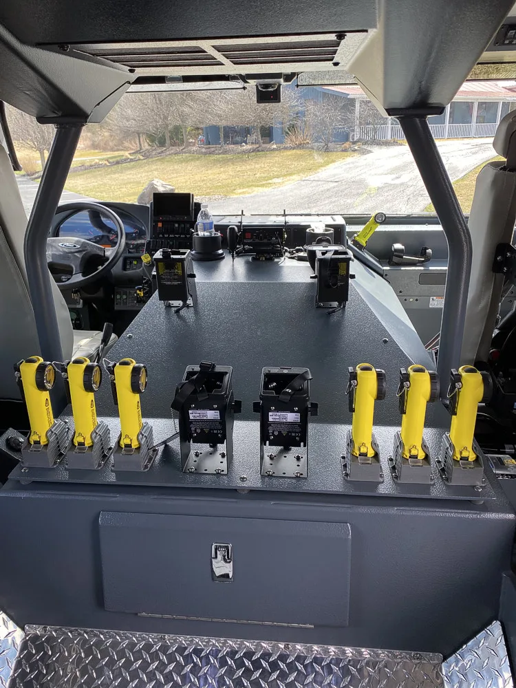 Rear crew-seat close-up showing SCBA mounts and seat restraints