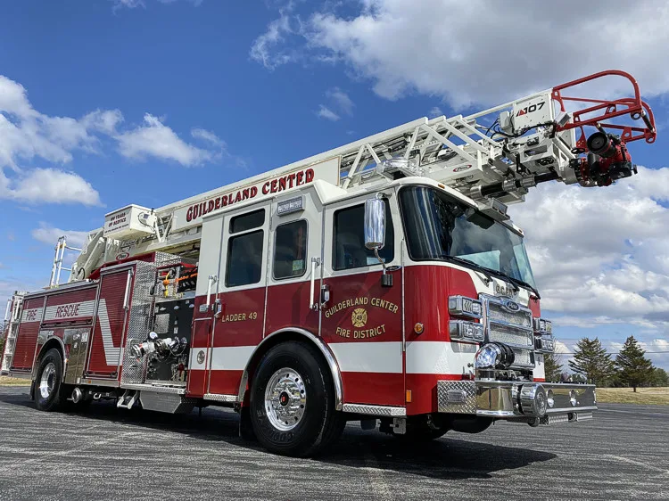 Front-right exterior view showing grille and aerial ladder above cab