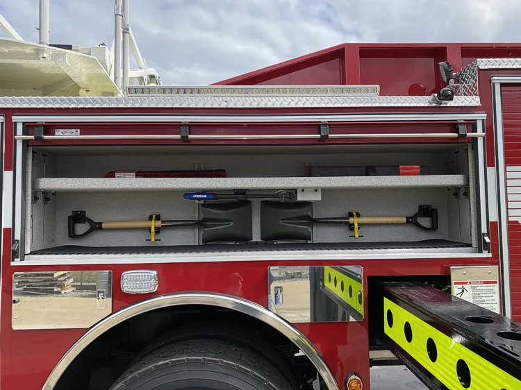 Open side compartment showing mounted hand tools in horizontal rack