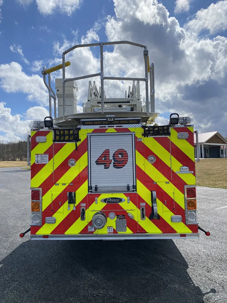 Rear view showing red-and-yellow chevrons and bucket platform above
