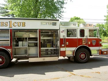 Driver-side profile with open body compartments showing shelf storage and equipment mounts