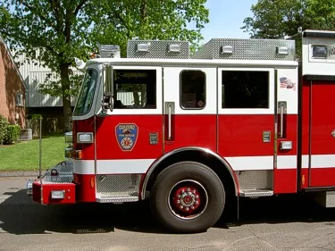 Driver-side cab close-up showing front wheel area and door crest