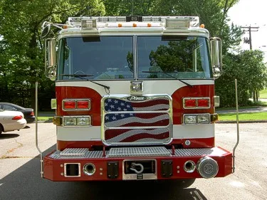 Head-on front view showing American-flag grille panel and bumper-mounted winch