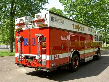 Rear-left exterior view showing rescue body, rear lights, and wheel layout