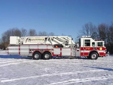 Passenger-side full profile showing stowed ladder sections and long side body