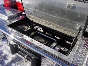 Front bumper compartment open view showing mounted winch assembly