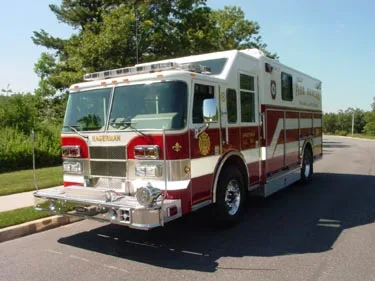 Front-right exterior view showing cab, wheel area, and side body compartments