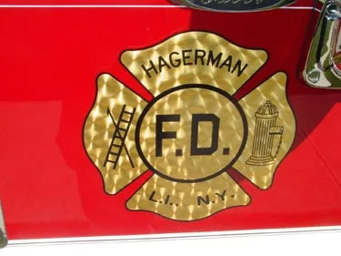 Maltese-cross emblem close-up on red cab door panel