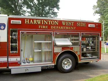 Driver-side mid-body view with open compartments showing shelves and equipment storage