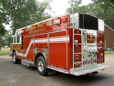 Rear-right exterior view showing rear body panel, cooling grille, and wheel area