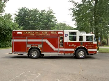 Driver-side profile view showing long rescue body and side compartments