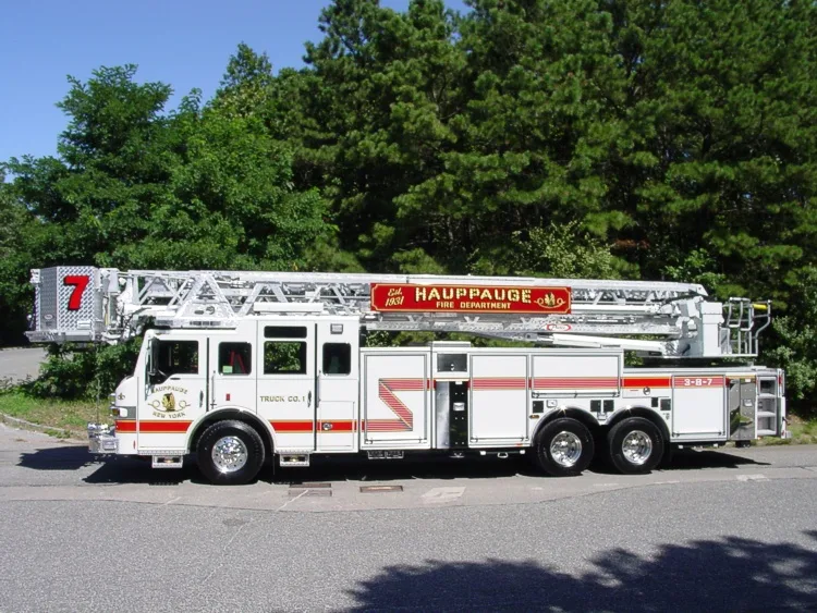 Straight driver-side profile of the ladder truck with stowed aerial and full wheelbase visible.