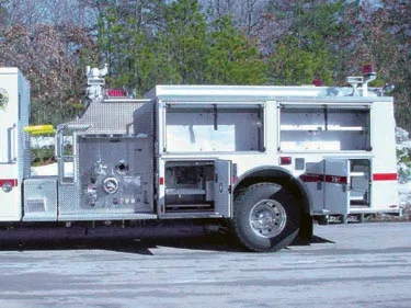 Driver-side profile view showing side compartments and wheel area