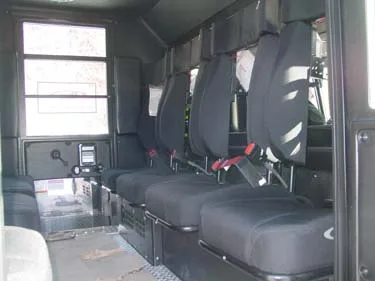 Rear crew cab interior view showing bench seats and seatbelts
