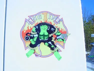 Side logo close-up showing cartoon-style emblem on white panel