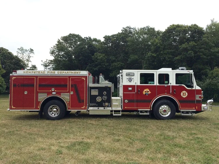 Driver-side full profile showing the midship pump panel, side compartments, and wheel area.