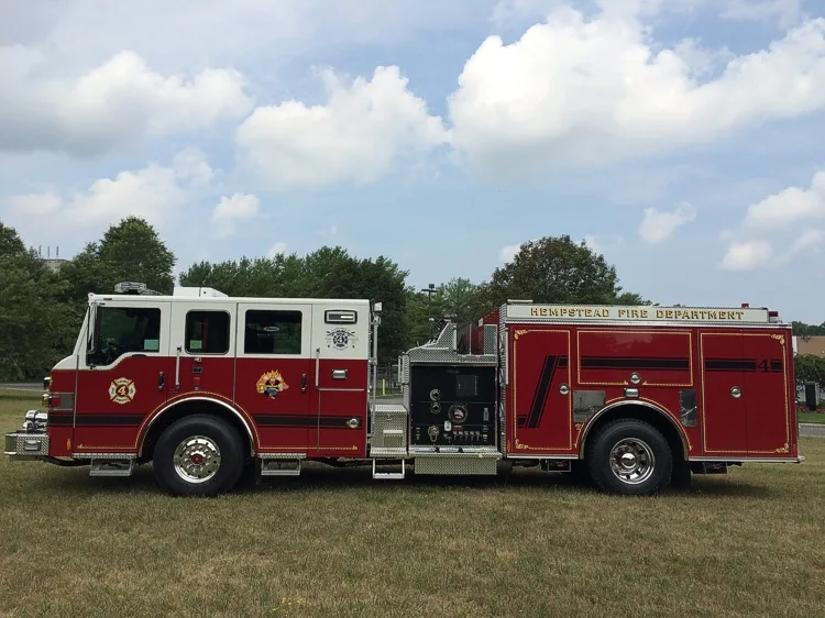Officer-side full profile view showing the pump panel section, side compartments, and rear wheel.