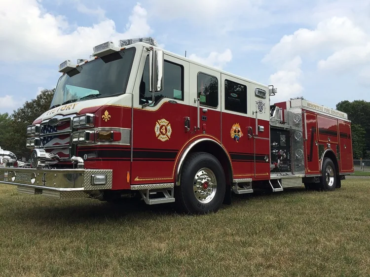 Front-left three-quarter view highlighting the chrome grille, cab, pump panel, and side body.