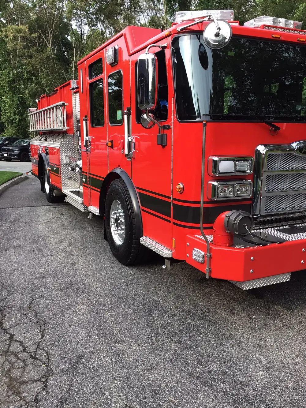 Front-right exterior view showing cab, wheel area, and side ladder