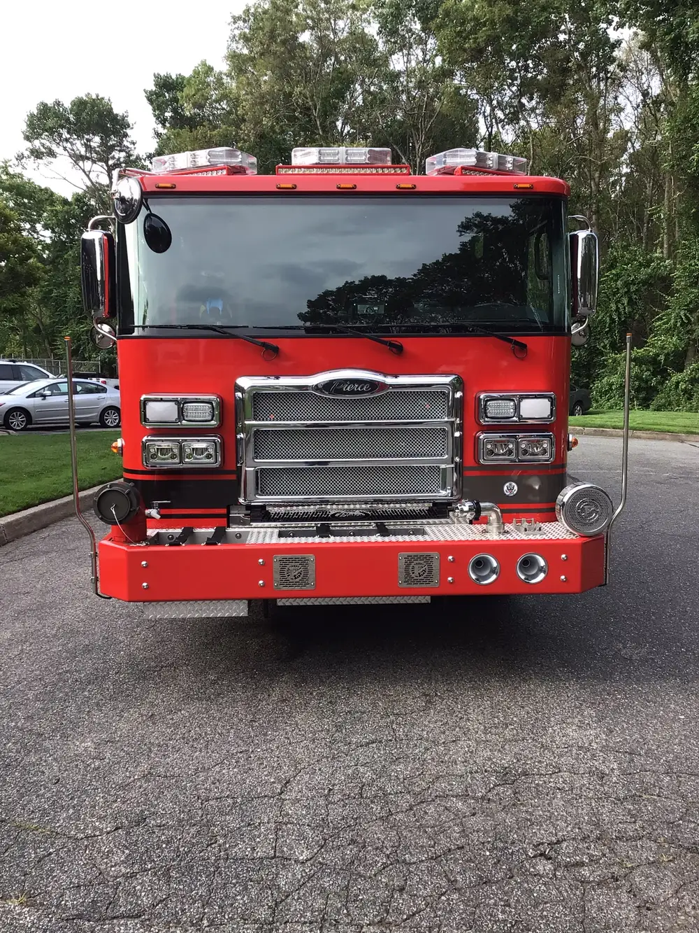 Head-on front exterior view showing grille, bumper, and warning lights