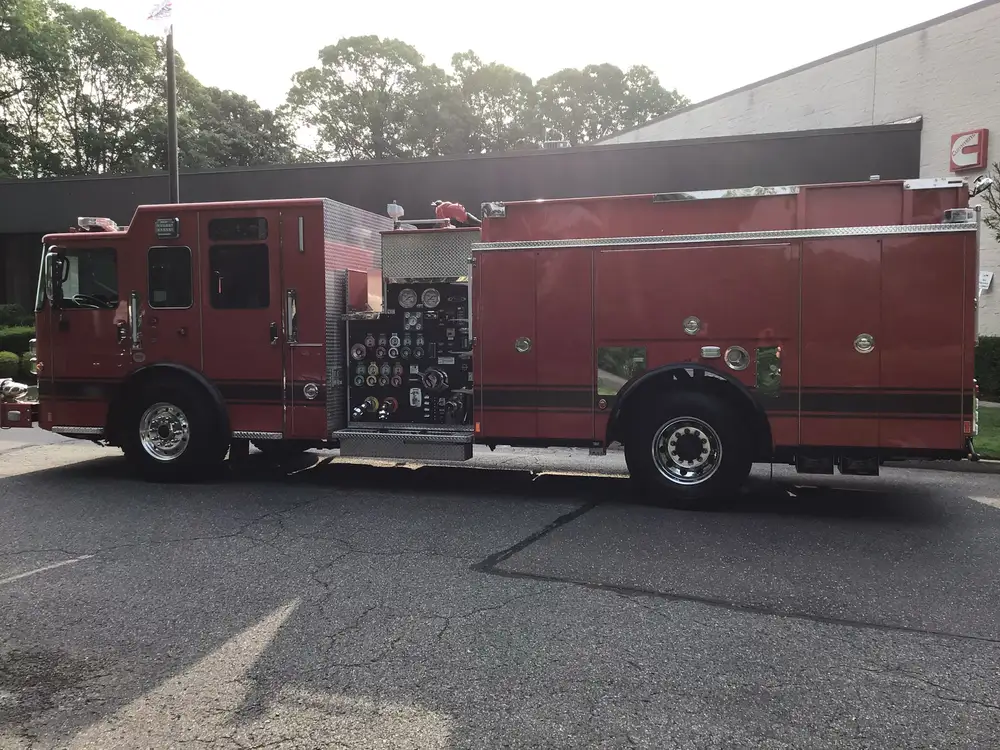 Driver-side full profile showing exposed pump panel and body compartments