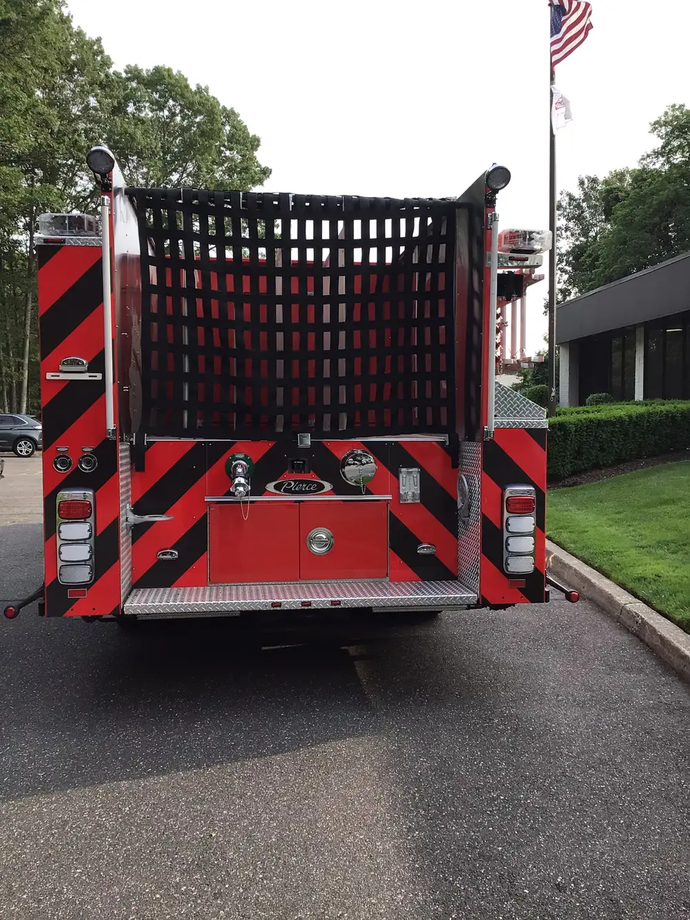 Rear view showing black-and-red chevrons and hosebed netting