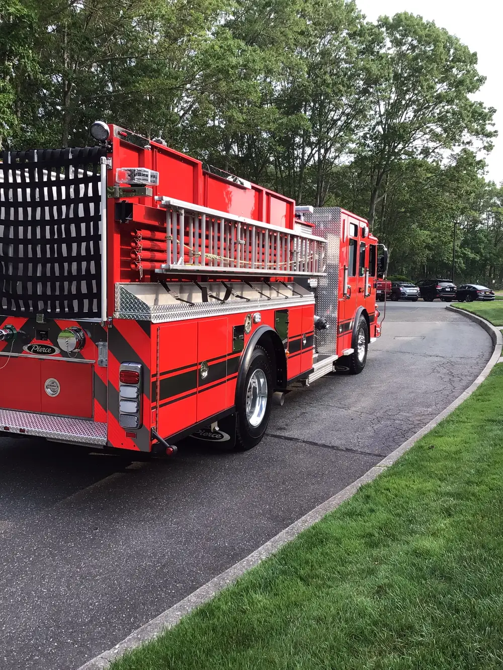 Rear-right exterior view showing side ladders and hosebed rails