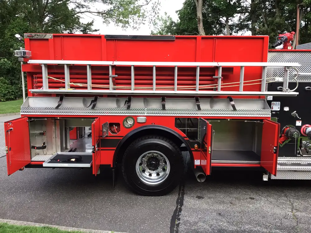 Driver-side rear view with open lower compartments and wheel area