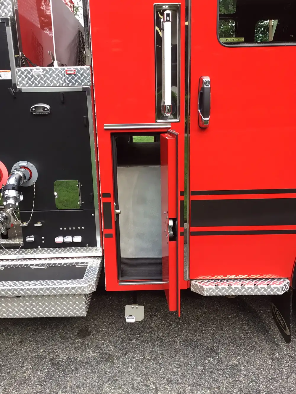 Narrow vertical compartment open behind cab with empty interior