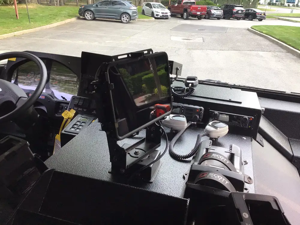 Center console close-up with tablet mount, radios, and charging docks