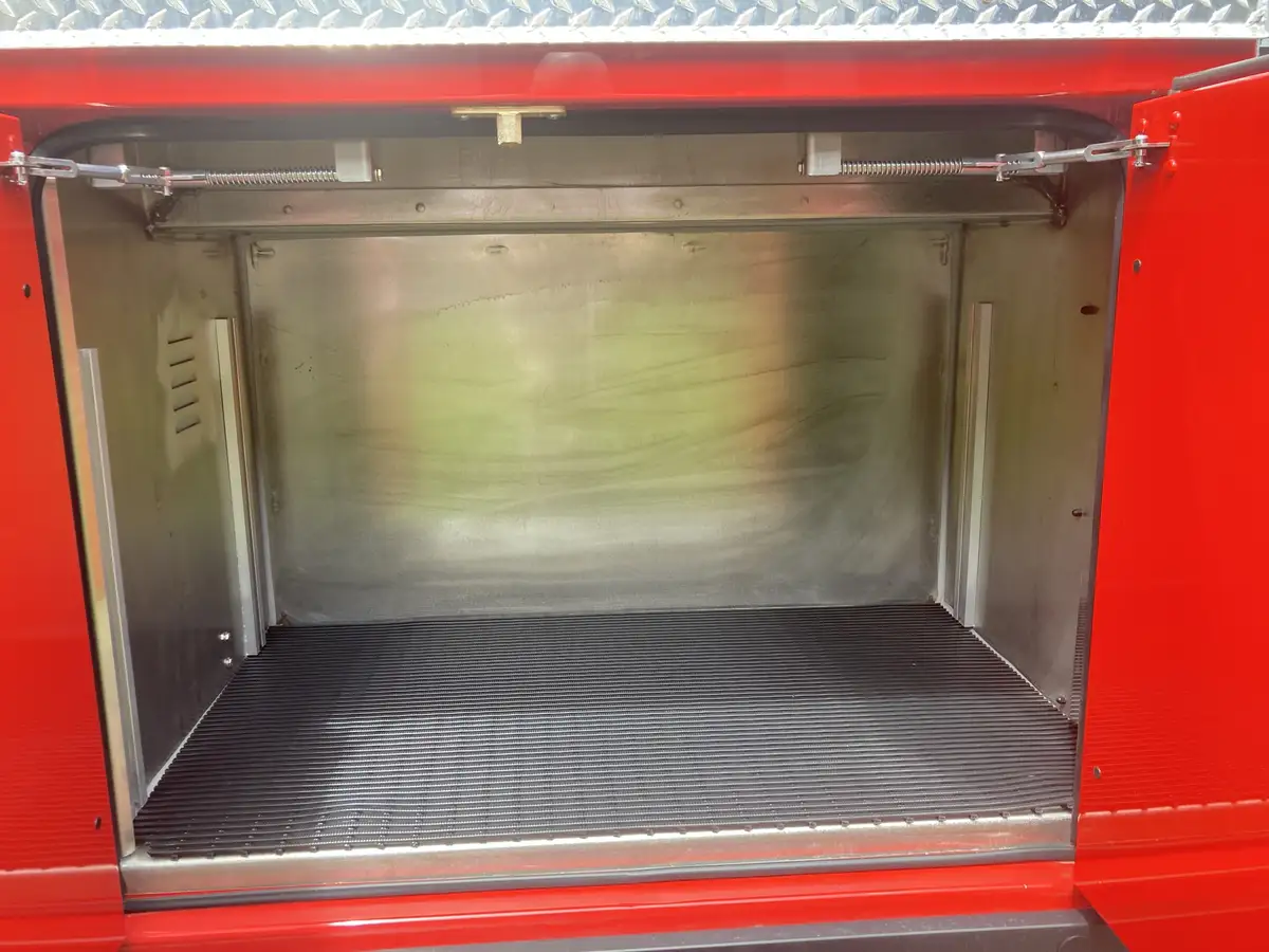 Empty side compartment close-up showing open bay and ribbed floor