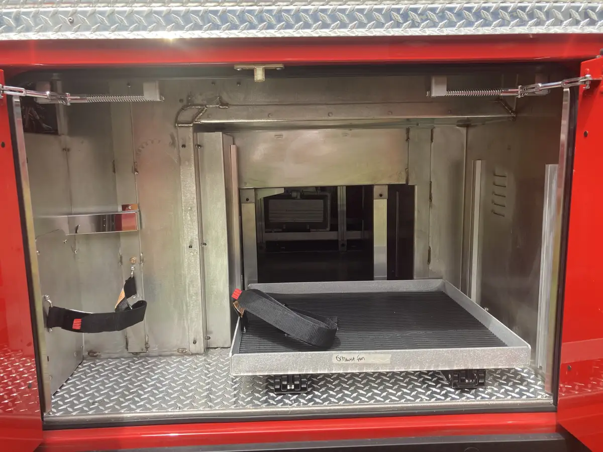 Open compartment with slide-out tray and center passthrough opening