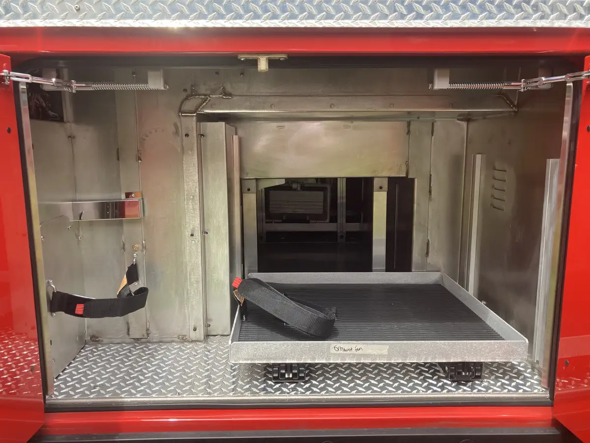 Open compartment with pull-out tray and passthrough to opposite side