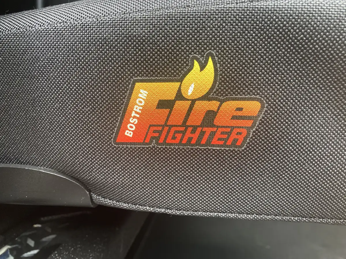 Rear crew bench view showing SCBA seats and red shoulder restraints