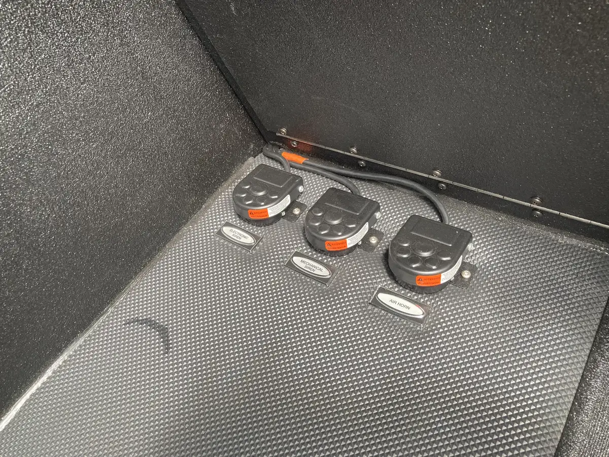 Crew seat side close-up showing blue SCBA bracket mount