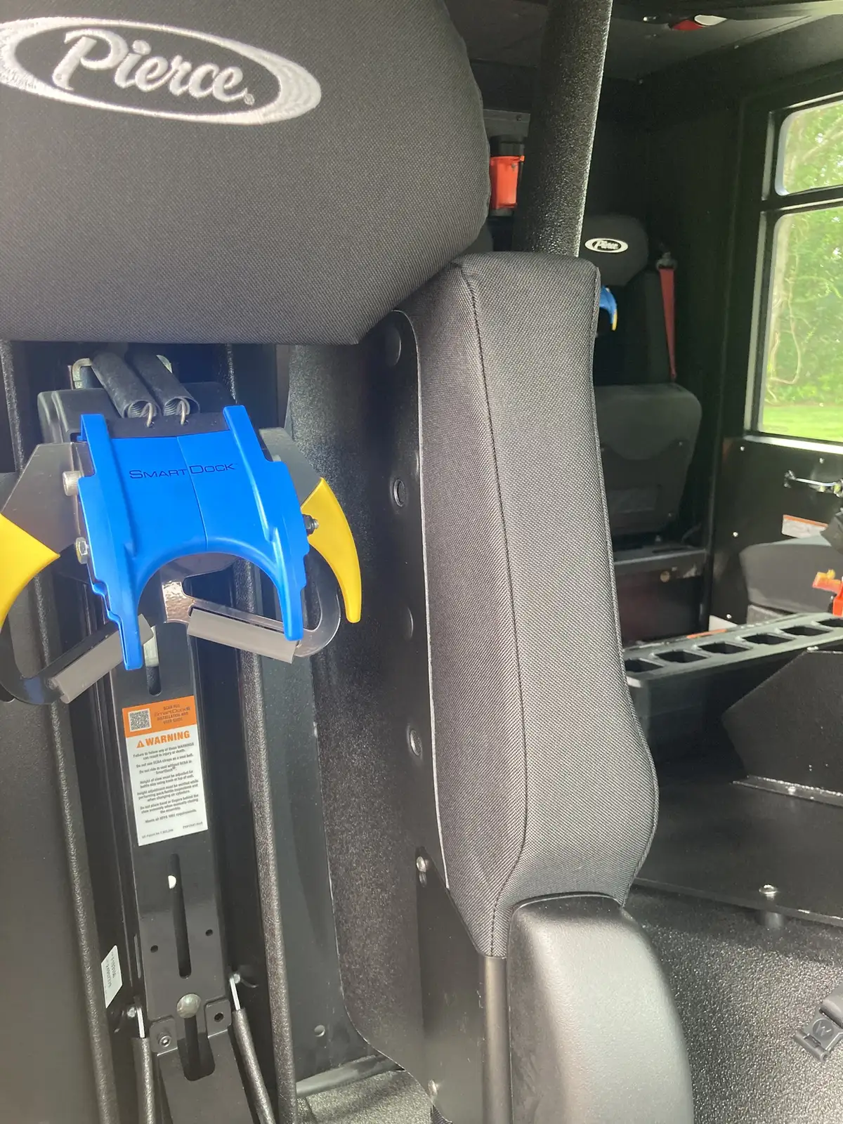 Pierce logo embroidery close-up on black seat headrest