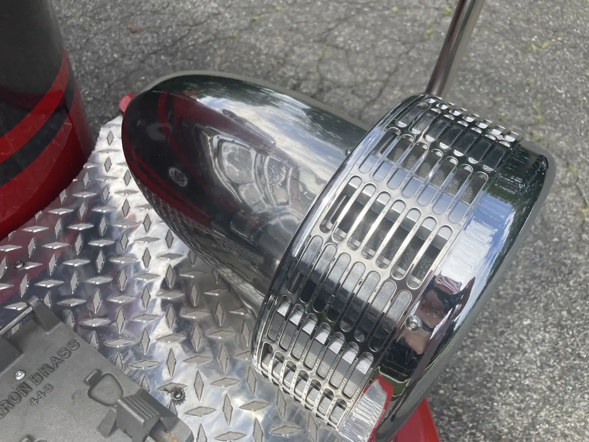 Chrome intake elbow close-up on diamond-plate bumper deck
