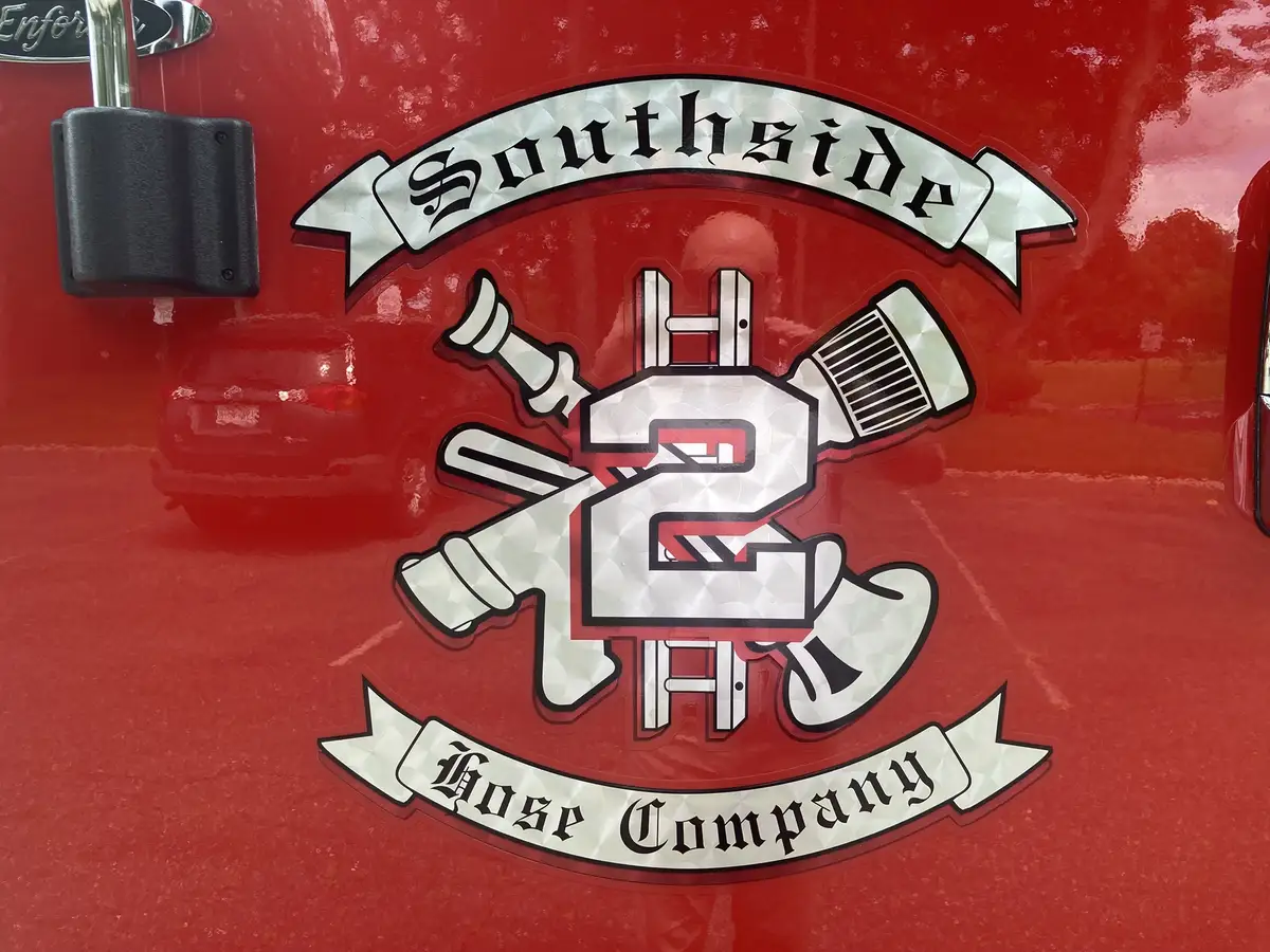 Round custom build badge close-up on black interior panel