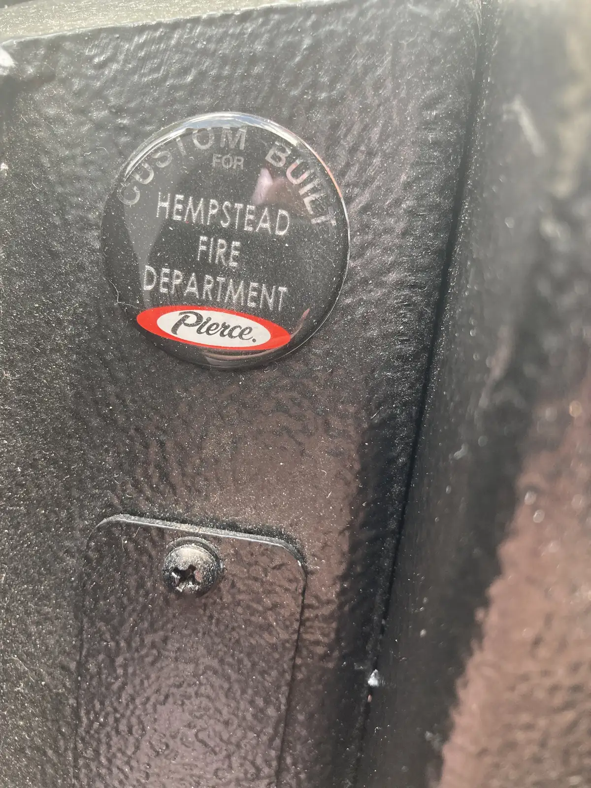 Pierce oval emblem close-up on black interior trim